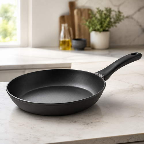 Black frying pan on a kitchen counter 